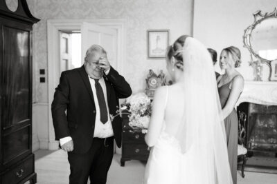 Emotional moment at wedding, father and bride, vintage room.