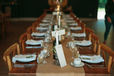 Elegant dining table setup with lit candles and menus.
