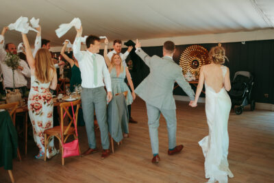 Wedding guests dancing and celebrating in a reception hall