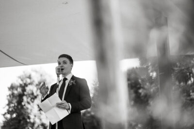 Groom giving speech at wedding ceremony.