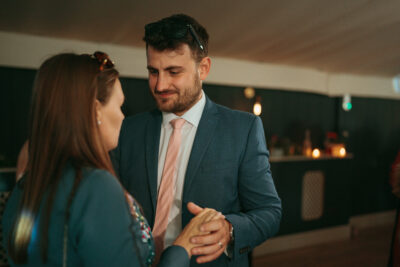Man and woman engaging in conversation at event.