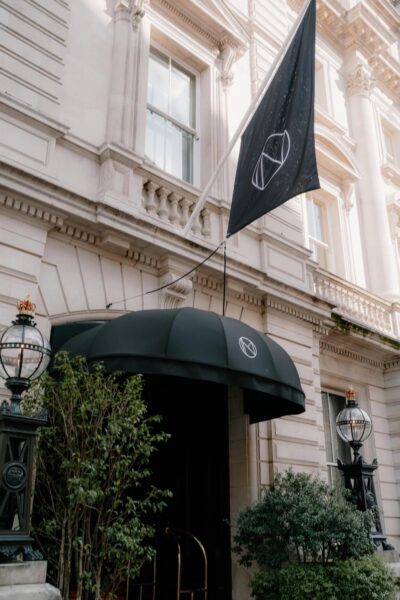 Elegant building facade with black flag and awning.