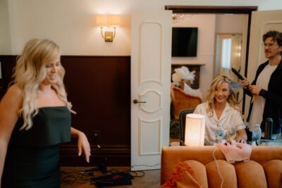 Hairdresser styling woman's hair in salon.