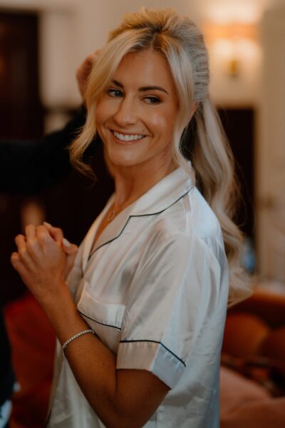 Smiling woman in silk nightwear getting ready