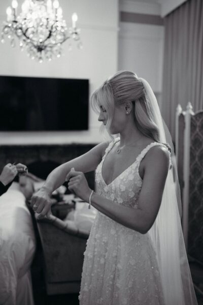 Bride preparing for wedding in elegant dress.