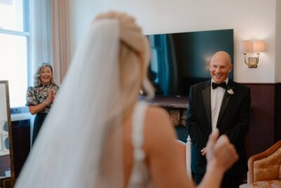Bride's father smiles seeing her in dress