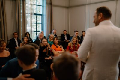 Audience smiling during a speech at event.