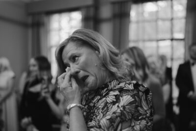 Woman wiping tears, emotional moment.