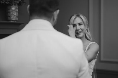 Bride wipes tear during wedding ceremony
