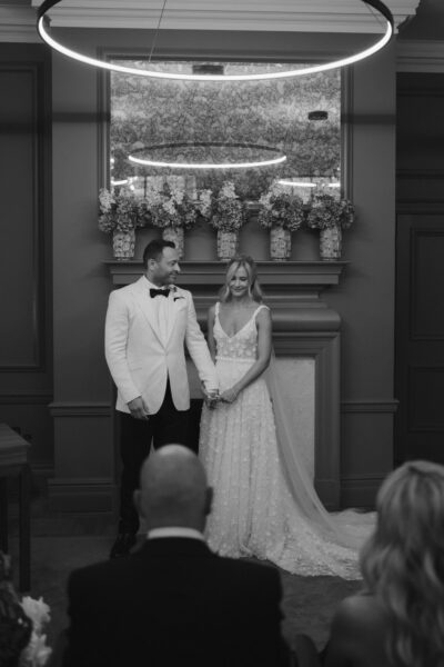Bride and groom holding hands during ceremony.