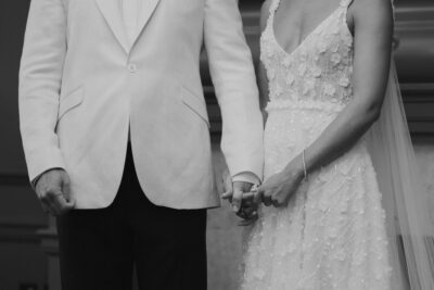 Bride and groom holding hands at wedding