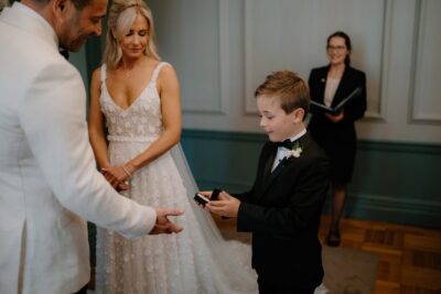 Boy presents rings at wedding ceremony
