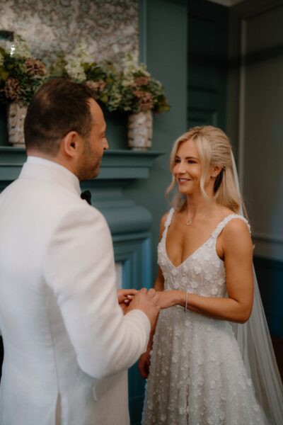 Bride and groom exchanging rings at wedding.