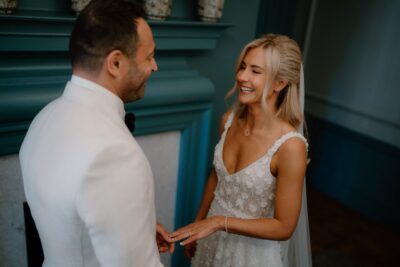 Bride and groom exchanging vows indoors.