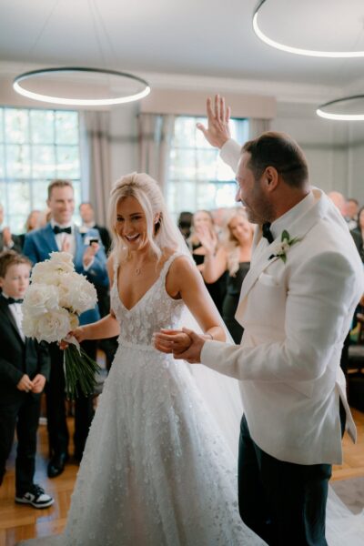 Couple joyfully dancing at their wedding ceremony.