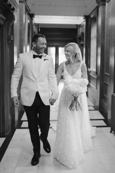 Happy couple walking together on wedding day.