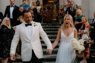 Bride and groom exit ceremony with confetti celebration.