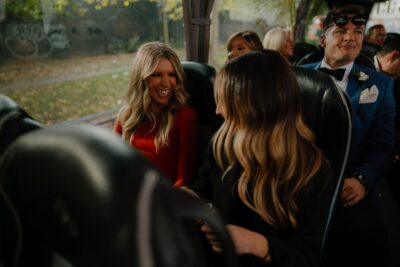 People smiling and laughing on a bus journey.