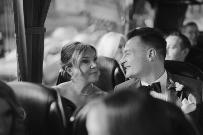 Smiling couple on a bus journey together.