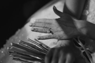 Elegant hands with diamond ring and bouquet.