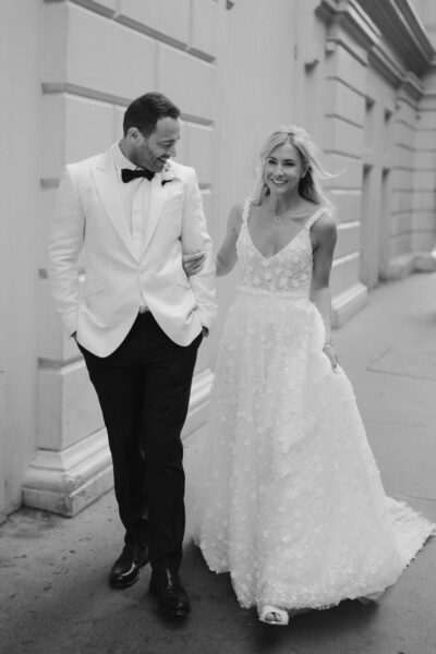 Bride and groom walking arm in arm