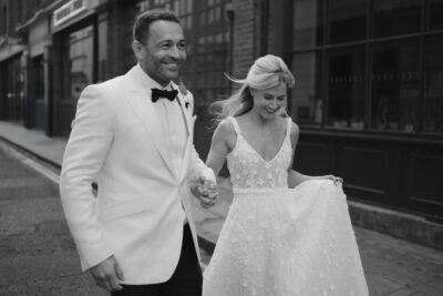 Elegant couple walking outdoors in wedding attire