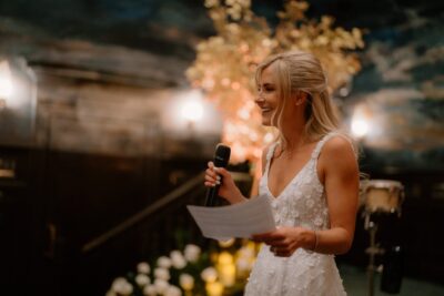 Woman giving a speech at a wedding reception.