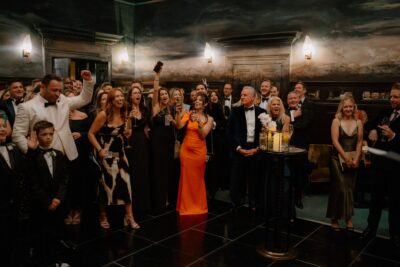 Joyful group celebrating at elegant indoor event.