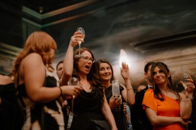People celebrating with drinks at a party event.