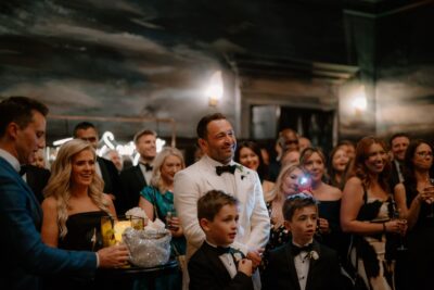 Group of people dressed formally, smiling at an event.