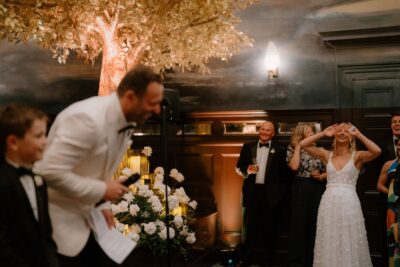 Wedding speech under golden tree decorations.