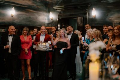 Elegant party with guests enjoying drinks and laughter.