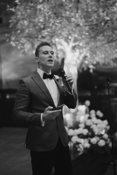 Man giving speech at wedding ceremony.