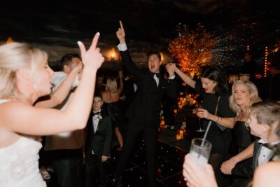 People dancing joyfully at a formal event celebration.