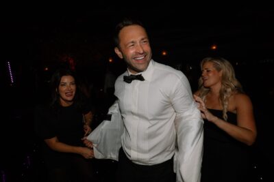 Smiling man at party with friends.