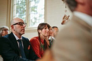 Guests listening intently at a wedding ceremony.