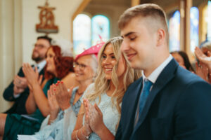 Guests clapping at a joyful event.