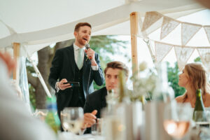 Man giving speech at wedding reception