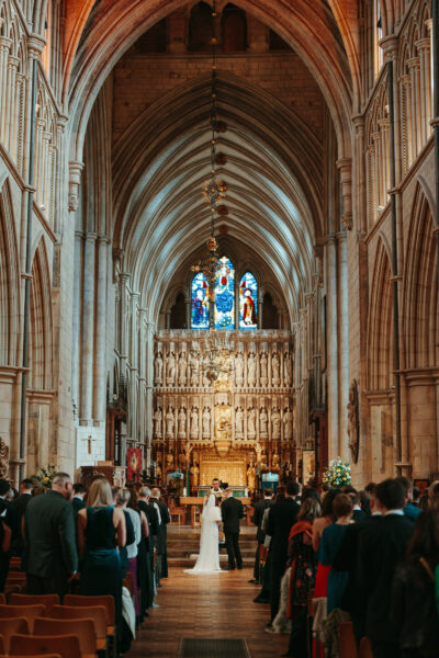 Wedding ceremony in gothic church interior.