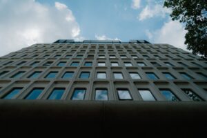Modern building with geometric windows against blue sky.