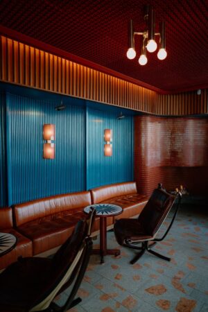 Retro lounge with leather seating and blue accents.