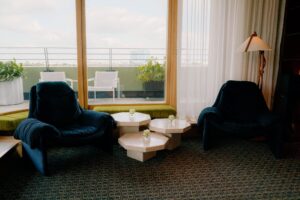 Modern lounge with chairs and coffee tables.
