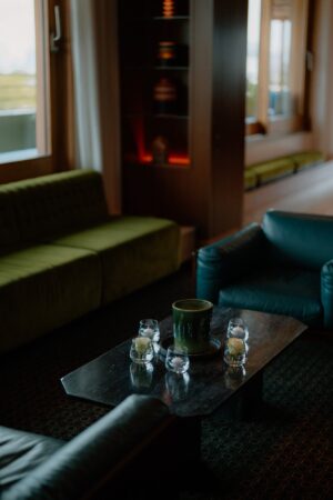 Cosy living room with green sofas and candles