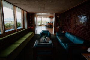 Modern living room with city view through windows.