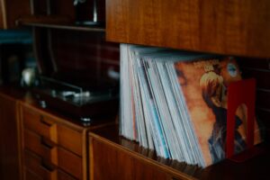 Vinyl records on a wooden shelf.