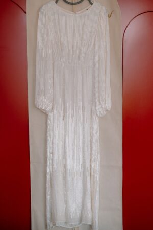Elegant white sequin dress on hanger