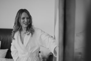 Woman smiling in bathrobe indoors.