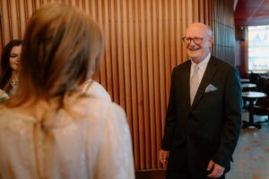 Man in suit smiling in conversation
