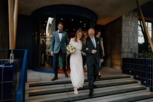Bride and groom walking down steps after wedding