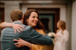 Woman hugs man with a joyful smile.